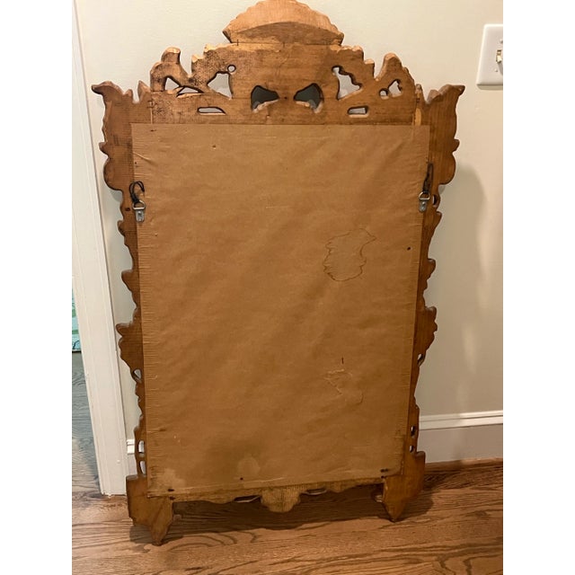 This beautiful heavily carved antique pine mirror is from a famous decorator’s store in Grosse Pointe, Michigan and...