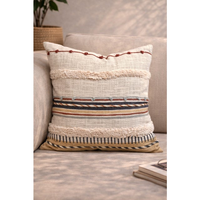 Elevate your space with this beautifully crafted cushion cover featuring a blend of woven textures, earthy stripes, and...