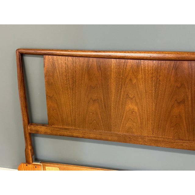 A mid century modern walnut full or queen size headboard designed by T.H. Robsjohn Gibbings for Widdicomb. Dated 1954....