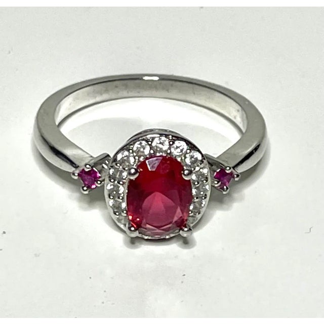 This is part of Chairish’s Costume Jewelry assortment. This is a lab made ruby cocktail ring. Size 8