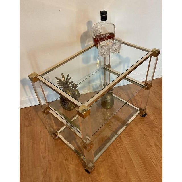 Very beautiful paris style lucite and gold french barcart by pierre vandel. Frame is completely made of acrylic with...
