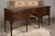 An English oak sideboard from the 19th century with five drawers, brass hardware, carved spandrels and straight legs....
