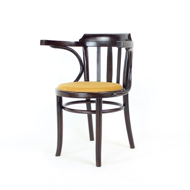Beautifully restored vintage bentwood armchair produced by TON in Czechoslovakia during the 1950s. This elegant piece...