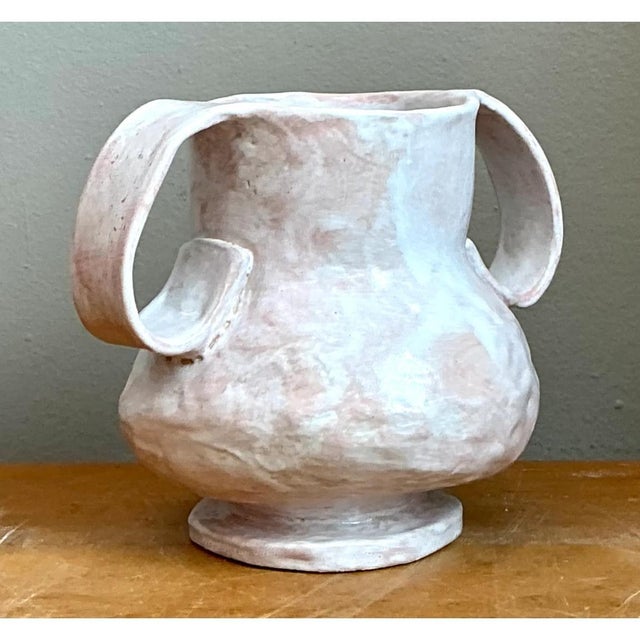 Exuding fluid, organic sculpture and mid-century art pottery allure, this vintage biomorphic ceramic double-handle vase...