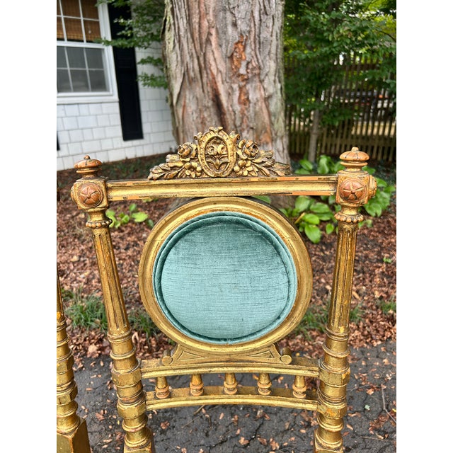 A striking pair of French Napoleon III giltwood side chairs, circa mid-to-late 19th century, executed in the Louis XVI...