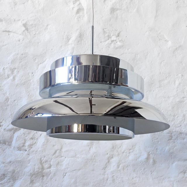 Large lampshade made up of several concentric pieces of chromed metal, through which the light filters, creating a...