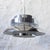 Large lampshade made up of several concentric pieces of chromed metal, through which the light filters, creating a...