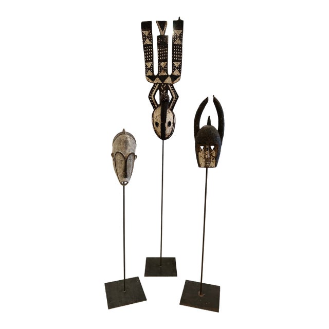 Collection of African Carved Wood Masks on Tall Custom Iron Stands For Sale