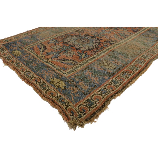 Highlighting modern design aesthetics and subdued elegance with a pop of color, this antique Bidjar rug beautifully...