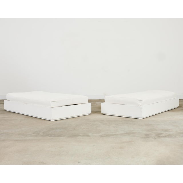 Large pair of patio and garden daybeds or benches crafted from lacquered mahogany with a piano white finish. The beds are...