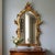 Wooden mirror crafted in the Venetian Baroque style, featuring a finely carved and gilded frame. The carving features a...
