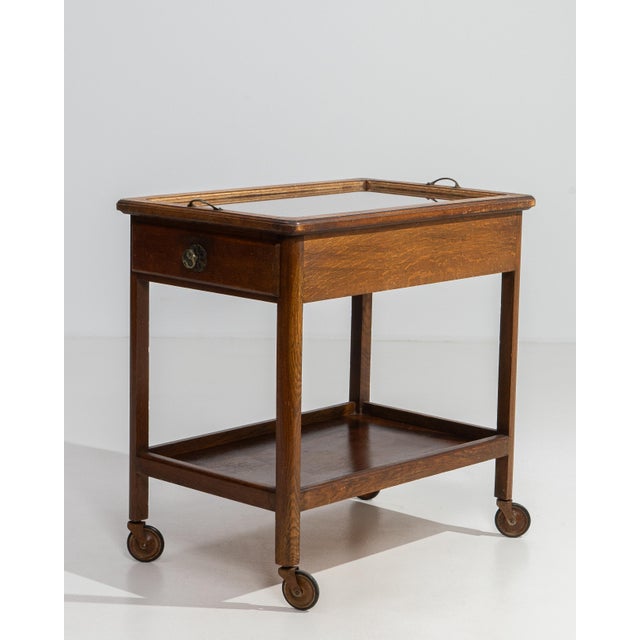 A classic mid-century French bar cart combining functionality with understated elegance. The simple frame and tiered...
