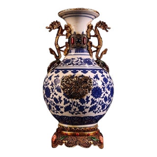 Vintage Chinese Blue and White Porcelain Vase With Gilt Bronze Dragon Handles and Elaborate Stand For Sale