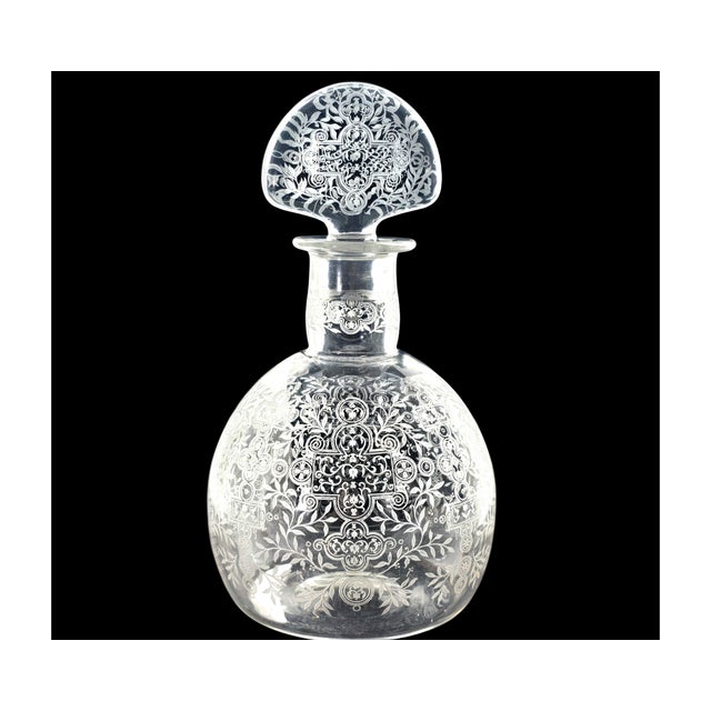 A wheel-engraved crystal decanter in the “Michelangelo” pattern by Baccarat, France, standing 10 inches tall with its...