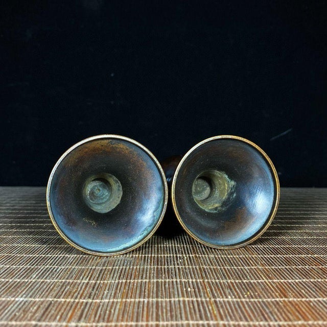 Elevate your tablescape or meditation space with this elegant pair of brass candle holders. Each candlestick features a...