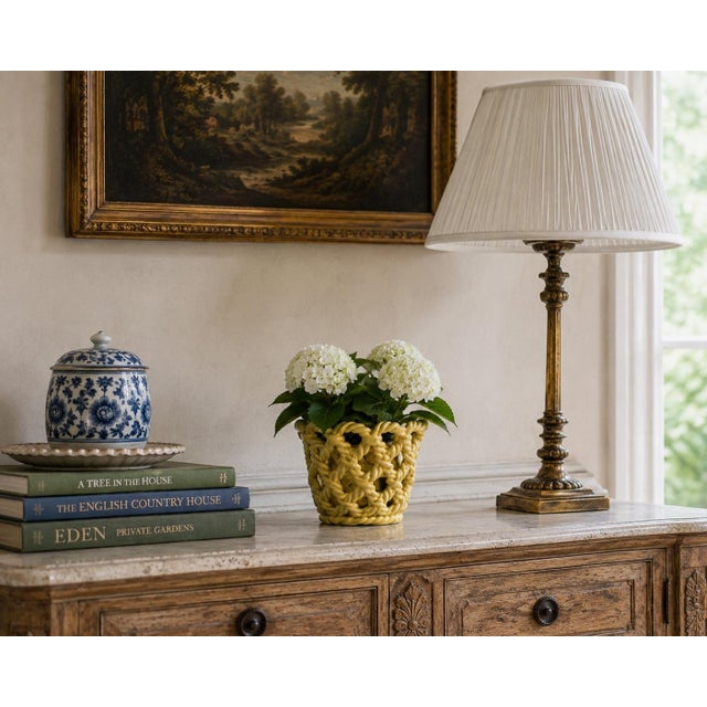 An elegant trompe l'oeil porcelain cachepot crafted in the form of a handwoven rope basket. Executed in glossy yellow...