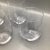 Four thin and light crystal Riedel stemless wine or scotch glasses with Riedel etched on the bottom. (Shown in photo...