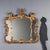 Carved and gilded wood mirror, featuring a rich and intricate design typical of the Rocaille movement. It features a...