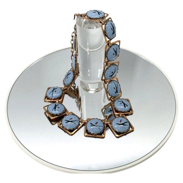 This is a mid-20th century Renoir style copper and enamel link necklace. There are fourteen square copper linked...