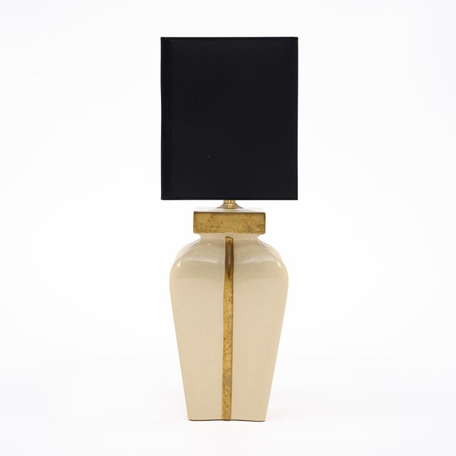 Single table lamp from the mid-century period in France. This piece has an urn shape with squared base and a cream glaze....