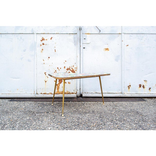 Coffee table with brass frame and Formica top. Designed by Maurizio Peregalli 1950s This piece is attributed to the...
