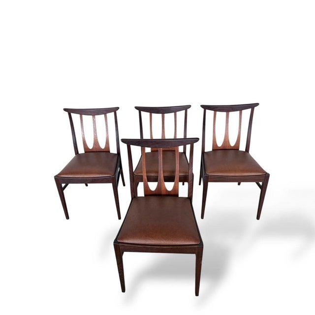 A superb set of four original g plan brasilia dining chairs, showcasing the iconic sculptural backrest design that defines...