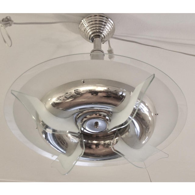 This round Art Deco chandelier made of nickel-plated brass is similar to the models from Petitot. The four vertical...