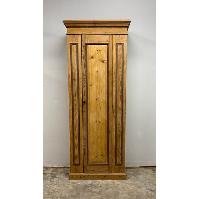 A most charming 19th century English pine wardrobe of compact and practical form. The piece is enriched with paneled...