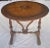 This Elizabethan style tilt top tea table is comprised of a round table top mounted onto the base with two cleats. It...