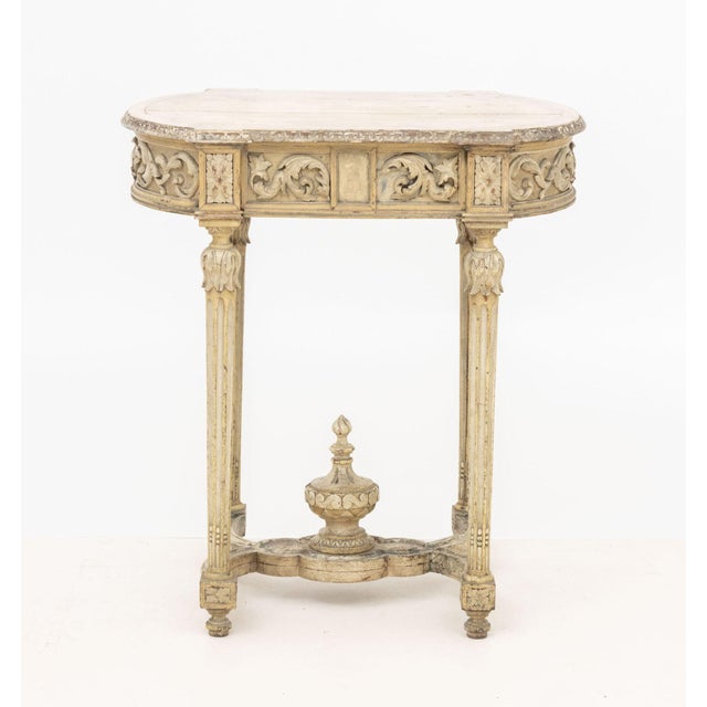 Louis XVI Style Carved Wood Occasional Table, painted white, with ornate foliate scrolling designs, fluted tapering legs,...