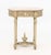 Louis XVI Style Carved Wood Occasional Table, painted white, with ornate foliate scrolling designs, fluted tapering legs,...