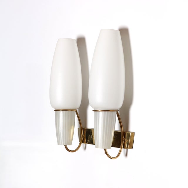 A pair of Italian Modernist wall scones. Venetian frosted glass elongated globes are suspended in patinated brass rings...