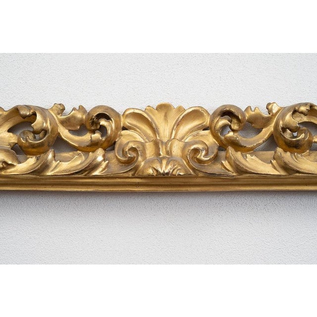 An antique gilded and carved wooden frame of Florentine origin dating from the early 19th century. The frame is...