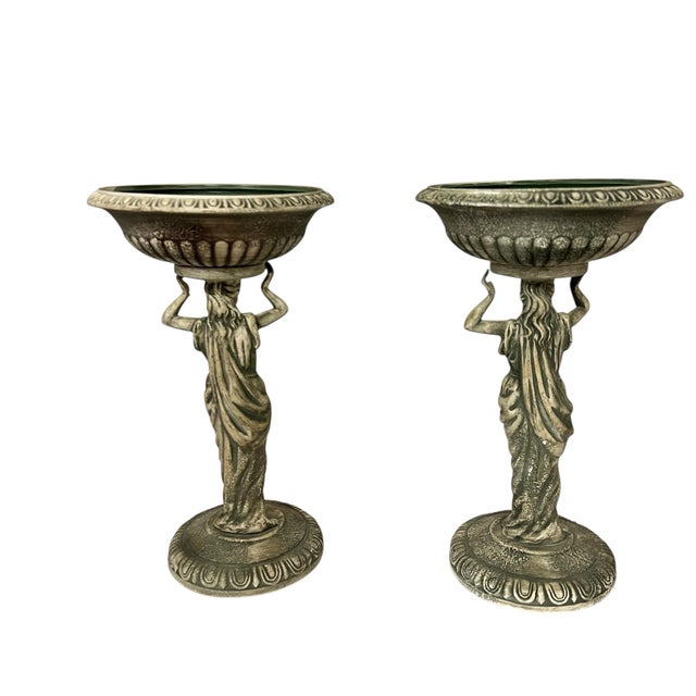 Vintage Grecian pedestal planter by Napcoware. Depicts a Grecian woman holding a bowl. Each measures 7.5” diameter x 12.5”...