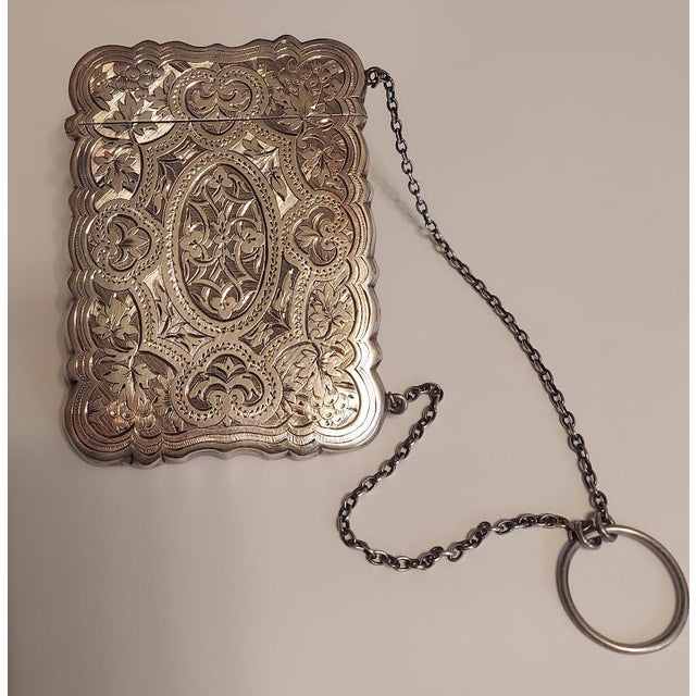 An unusually ornate example of a Victorian English sterling silver calling card case. Attributed to Hilliard & Thomason of...