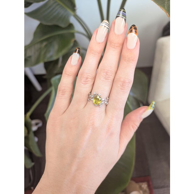 2.4ct leafy vine–inspired ring featuring a vivid 8×6 mm sphene accented with natural diamonds. Expertly crafted in solid...