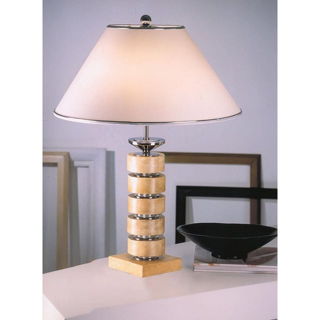 Hand made in Italy, this one-of-a-kind table lamp features a bronze cast structure with a sculptural parchment column...