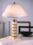 Hand made in Italy, this one-of-a-kind table lamp features a bronze cast structure with a sculptural parchment column...