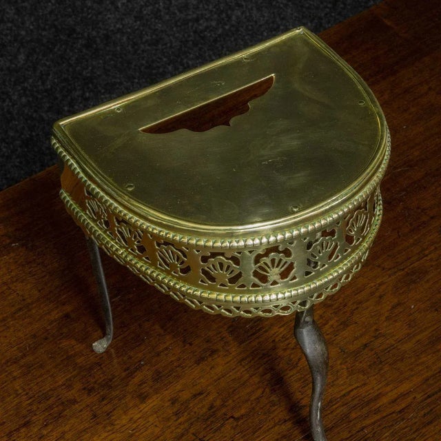 A beautiful demi lune shaped fireside footman from the late 18th Century. A most decorative finely pierced fretwork apron...