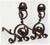 Large antique hand wrought iron andirons having scroll and ring motifs with chain.