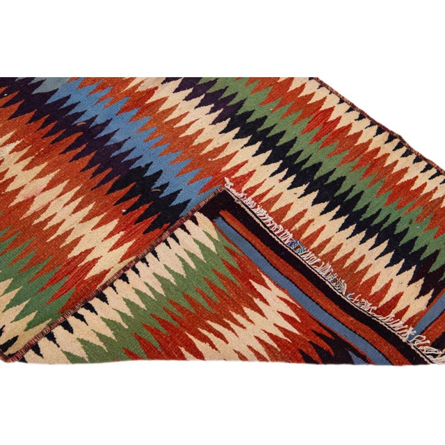Beautiful vintage Turkish Kilim hand-knotted wool rug with a rust field. This piece has multicolor accents in an all-over...