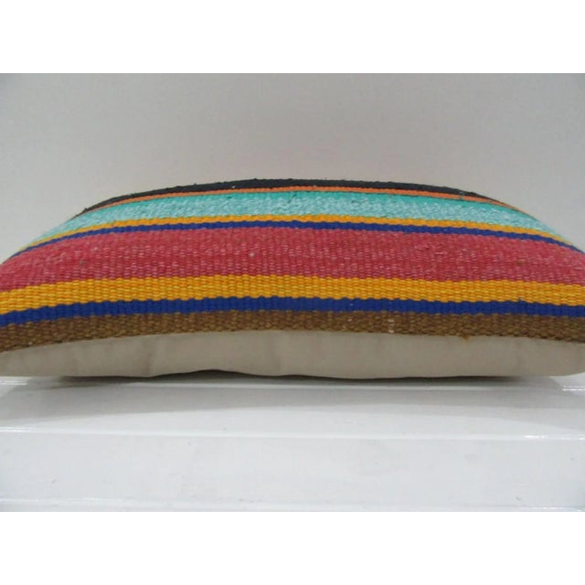 This is a pillow cover made from a vintage kilim rug. The piece was properly washed and ready to use. Pillow inserts not...