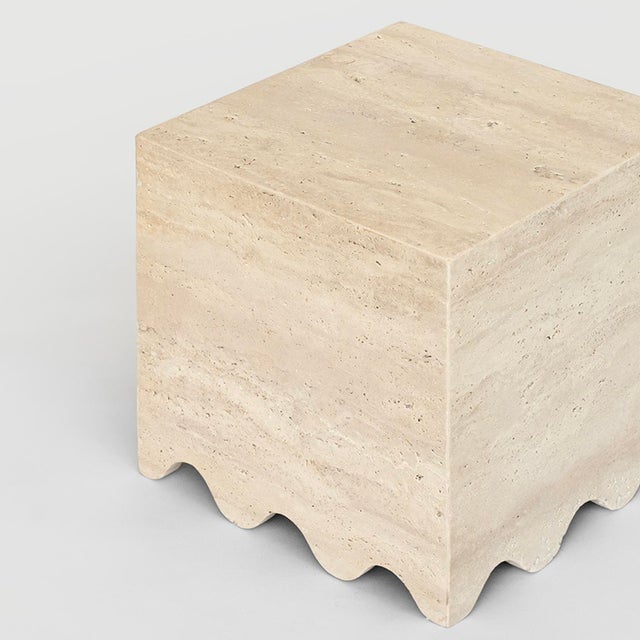 FLOW is a contemporary travertine marble side table with a clean shape and a wave detail at the bottom. The simple cube...