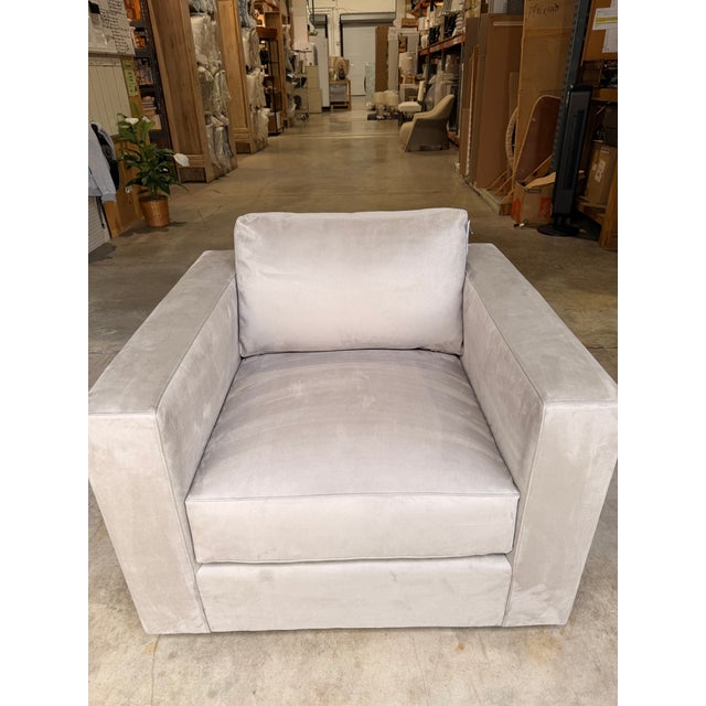 Contemporary accent chair featuring clean architectural lines and generously proportioned track arms for a refined, modern...