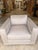 Contemporary accent chair featuring clean architectural lines and generously proportioned track arms for a refined, modern...