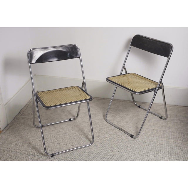 Set of 2 vintage folding chairs chrome rattan set with an Italian mid-century design, based on the iconic Plia model by...