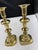 Pair of vintage solid brass candlesticks featuring a classic baluster design and octagonal bases. Each candlestick...