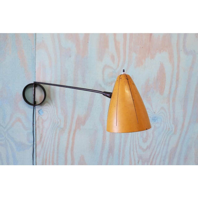 Rare form lamp attributed to Ben Seibel (1918-1985). This rotating task lamp wall sconce features a pivoting boom,...