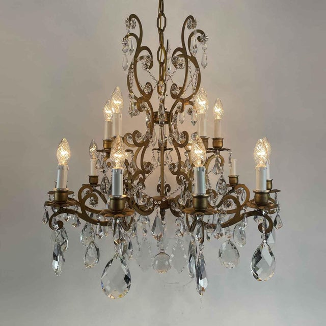 Gilded Iron and Crystal Chandelier, 15 lights on two levels, ten lower arms and five upper lights, curved double-volute...