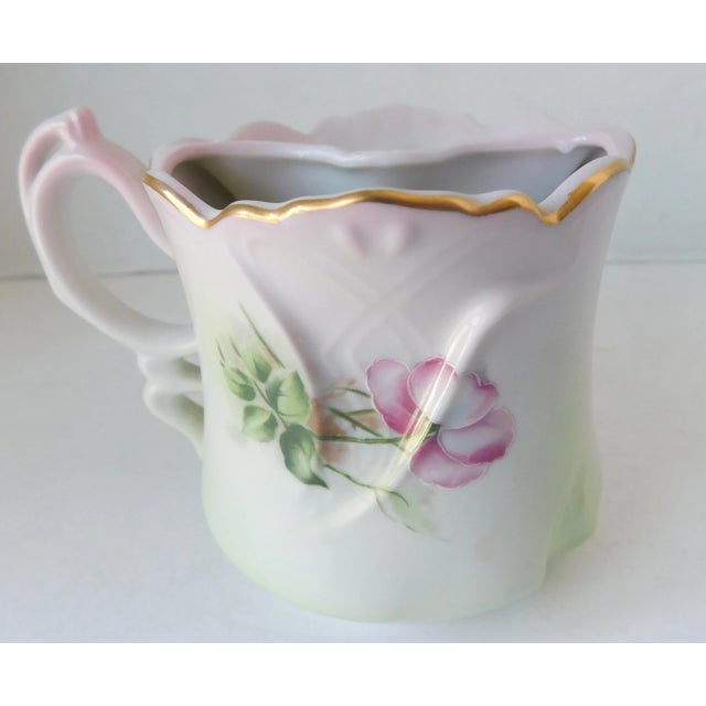 What a pretty pink and green hand-painted porcelain dogwood flower Nippon shaving mug from the 1890's. This charming piece...